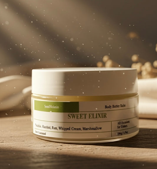 Jar of 'Sweet Elixir' body butter balm on a wooden surface with a blurred background